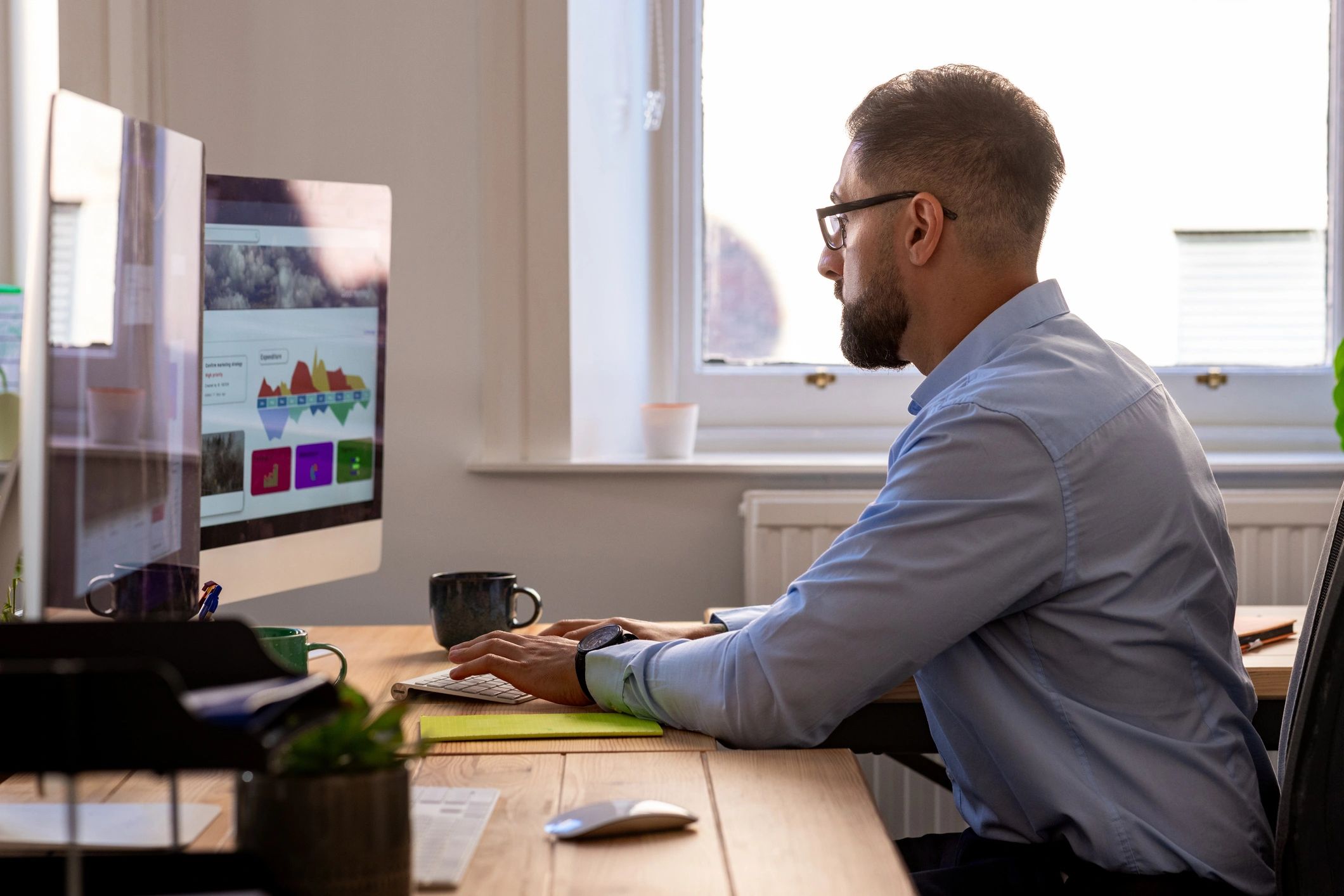 IT professional working at a desktop computer in a modern office